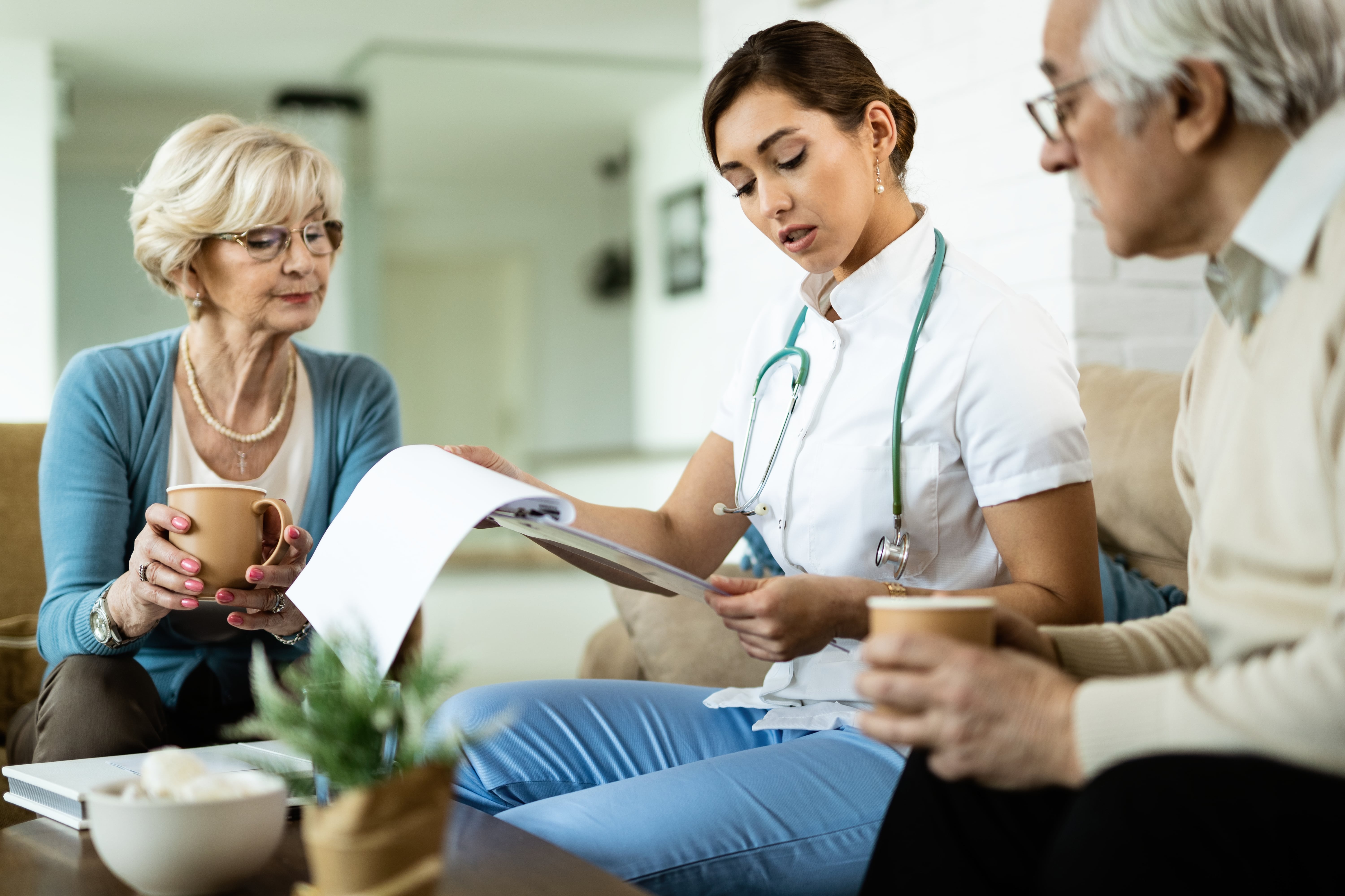 Nurse having a discusions with senior citizens