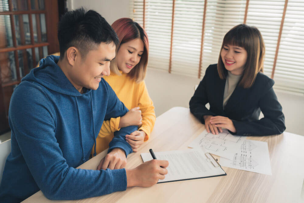 asian couple talking with an agent for a life insurance agent career